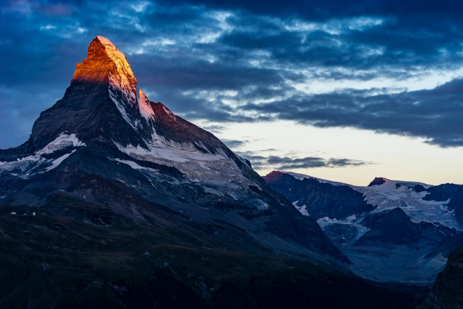Mountain ridge emerging above clouds in the Swiss Alps